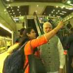 PM Modi taking selfie with metro commuters