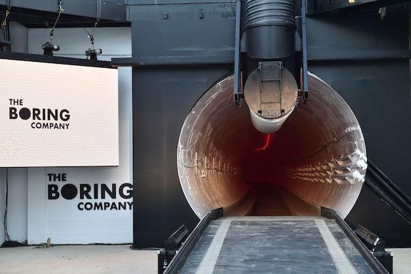 The Boring Company signage is displayed at the tunnel entrance before an unveiling event for The Boring Company Hawthorne test tunnel December 18, 2018 in Hawthorne, California. Musk’s Boring Company is set to bag two high-speed underground tunnel projects connecting Baltimore and Washington, D.C