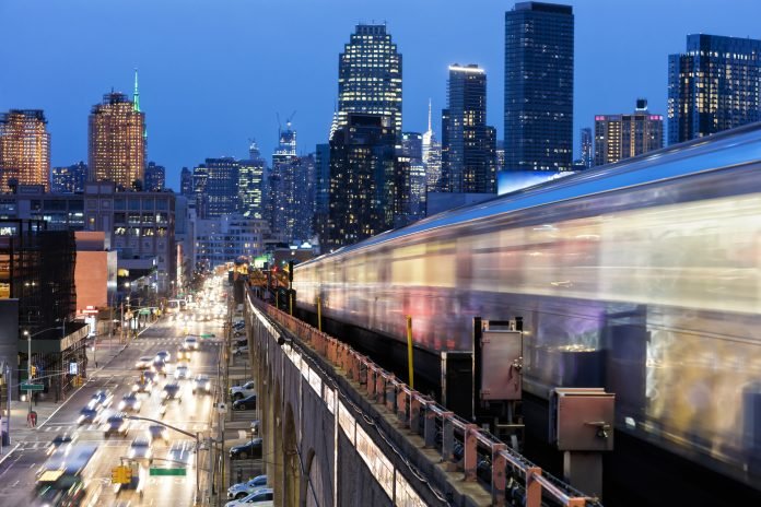 Subway Train Approaching Elevated Subway Station in Queens, New York